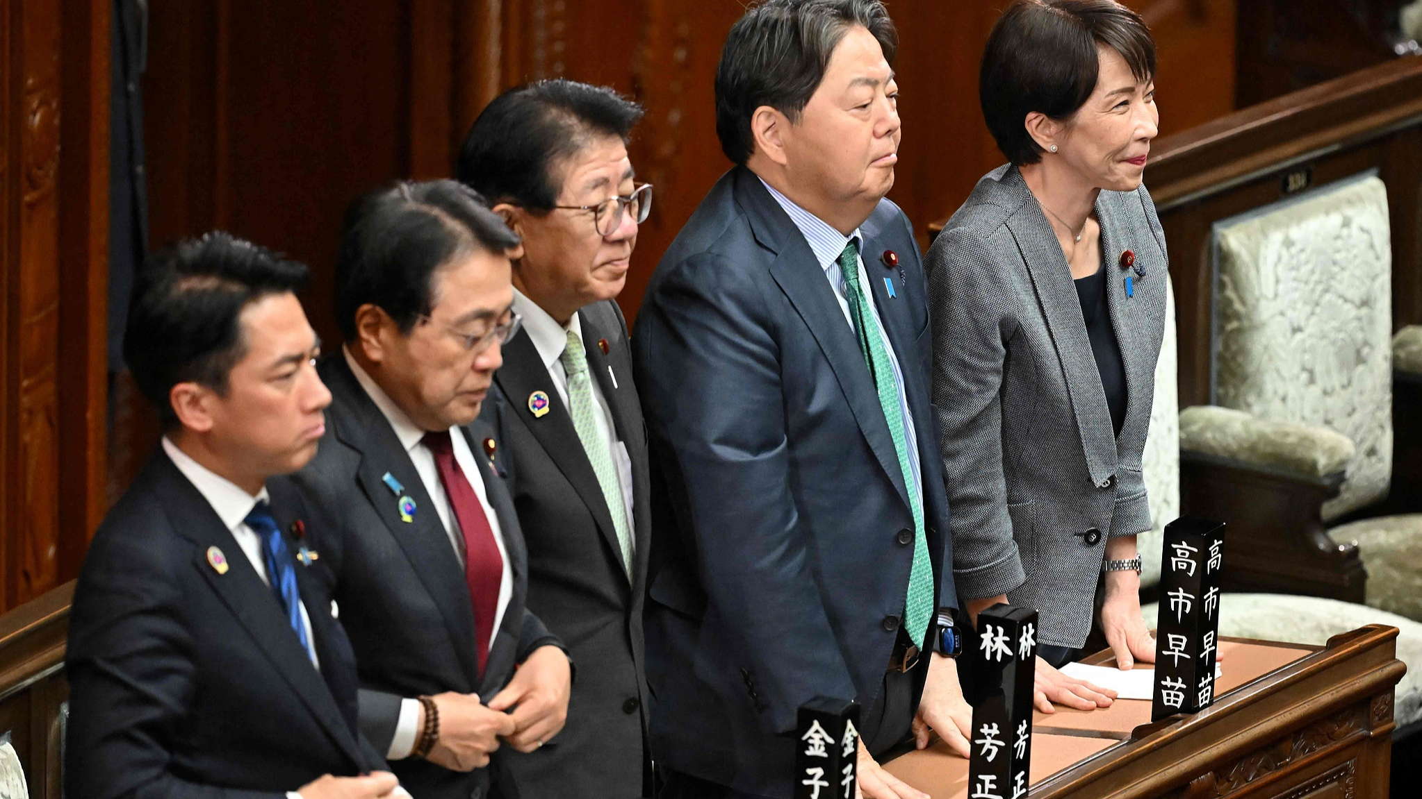 Japanese Prime Minister Sanae Takaichi (R) and her cabinet ministers stand to signal their support for the government's bill to establish a National Intelligence Bureau and a National Intelligence Council, during a vote at a plenary session of the House of Representatives in Tokyo, April 23, 2026. /CFP