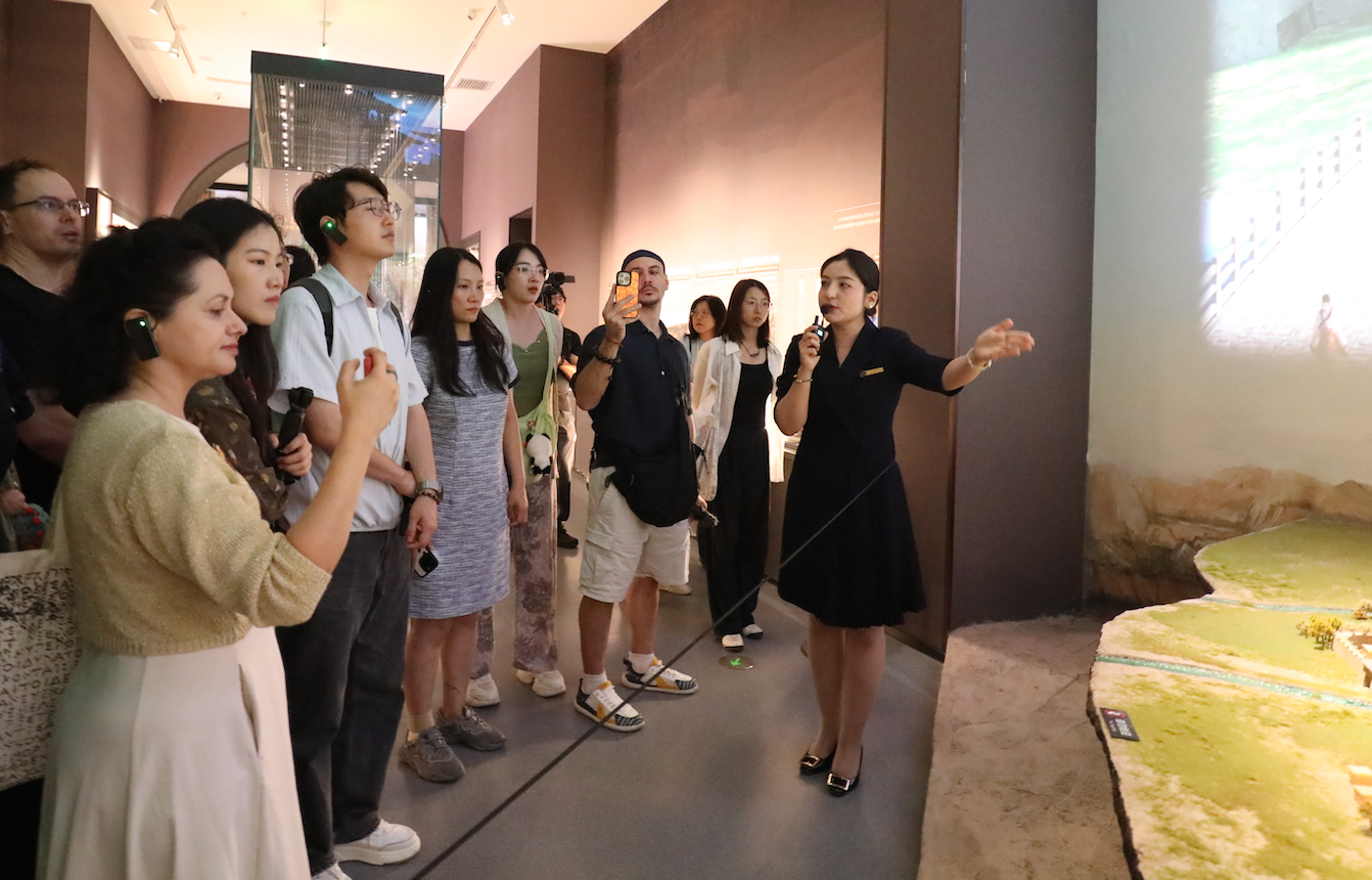 Influencers learn about Qiuci culture during a visit to the Qiuci Museum in Kuqa, Xinjiang, on August 3, 2026. /CMG