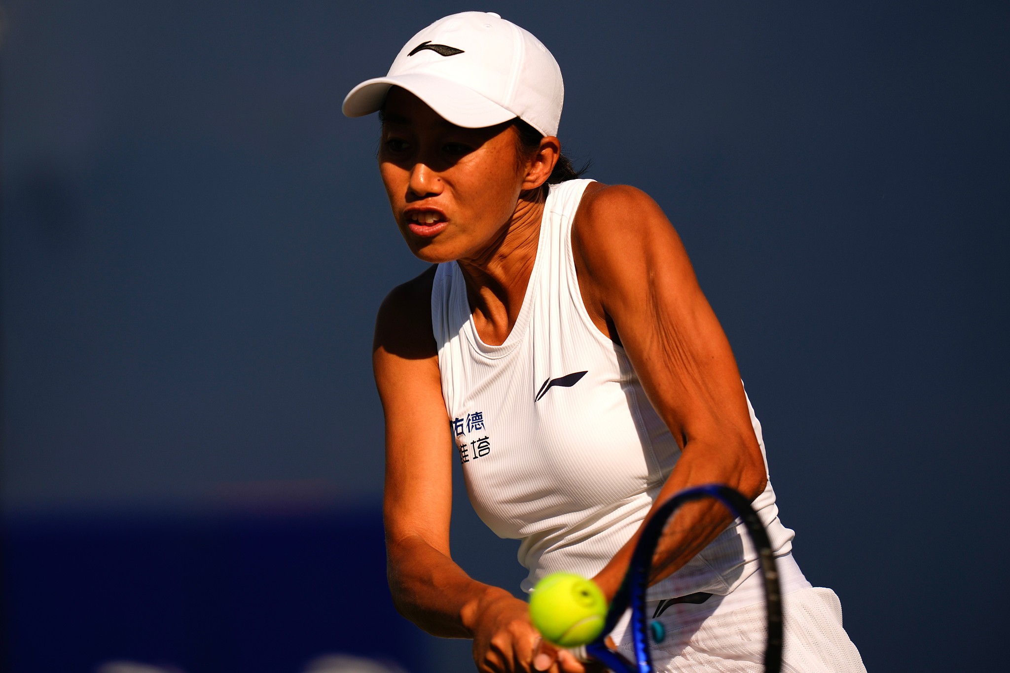 China's Zhang Shuai hits a return to Latvia's Jelena Ostapenko during a WTA National Bank Open tennis match in Toronto, August 4, 2026. /VCG