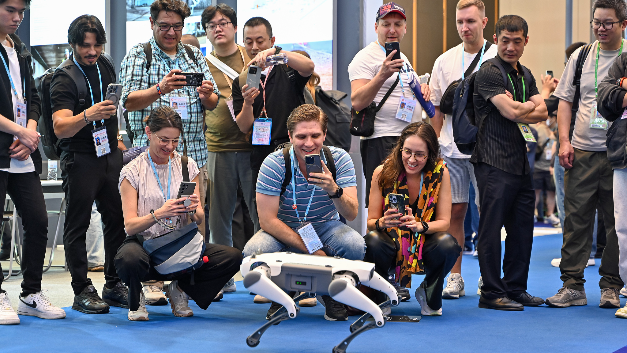 Visitors take a photo of a quadrupedal mechanical dog during the 137th China Import and Export Fair, in Guangzhou, south China's Guangdong Province, April 15, 2025. /CFP