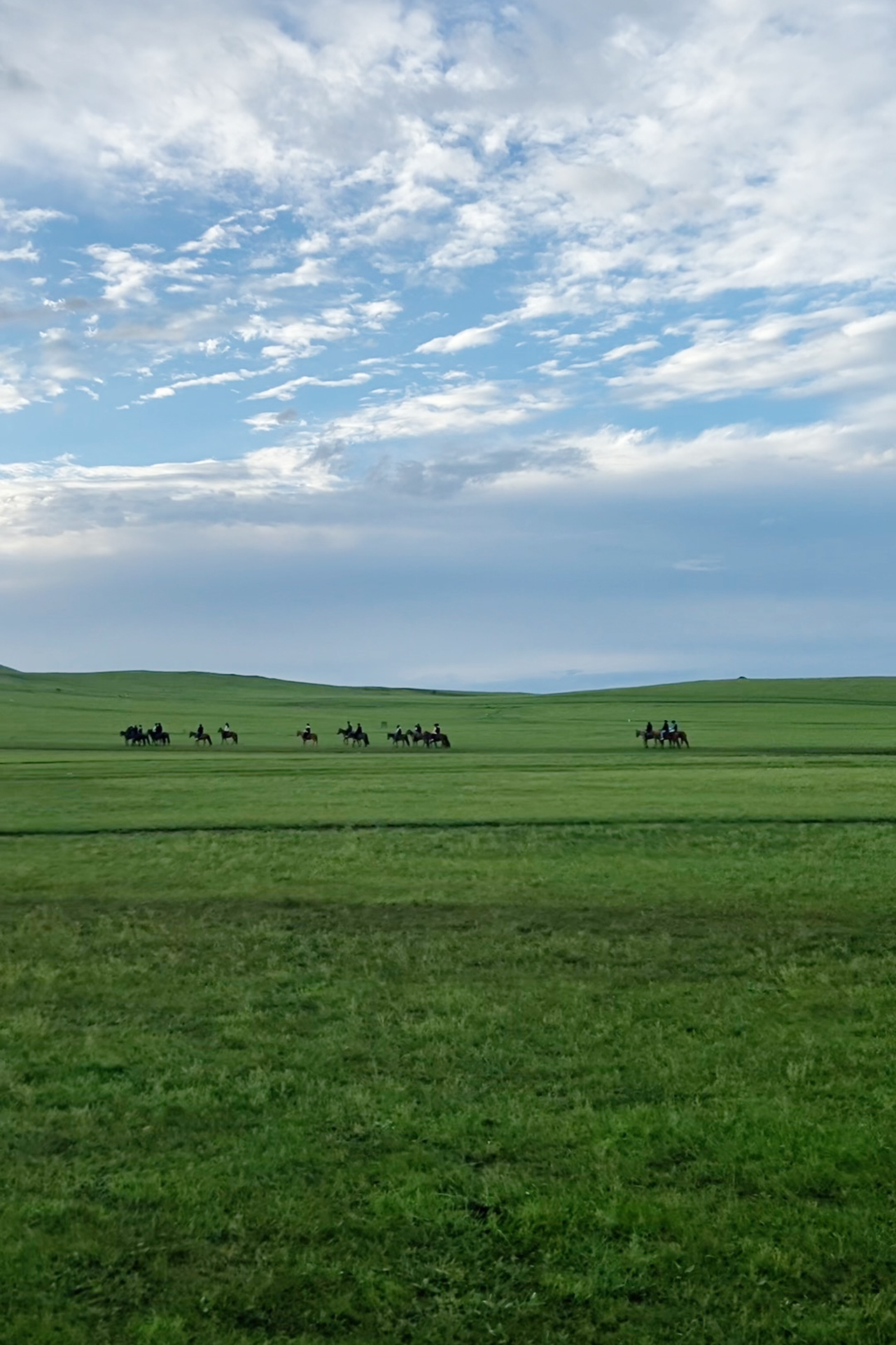 Visitors ride horses at sunset in Heishantou Town, Hulunbuir, Inner Mongolia. /CGTN