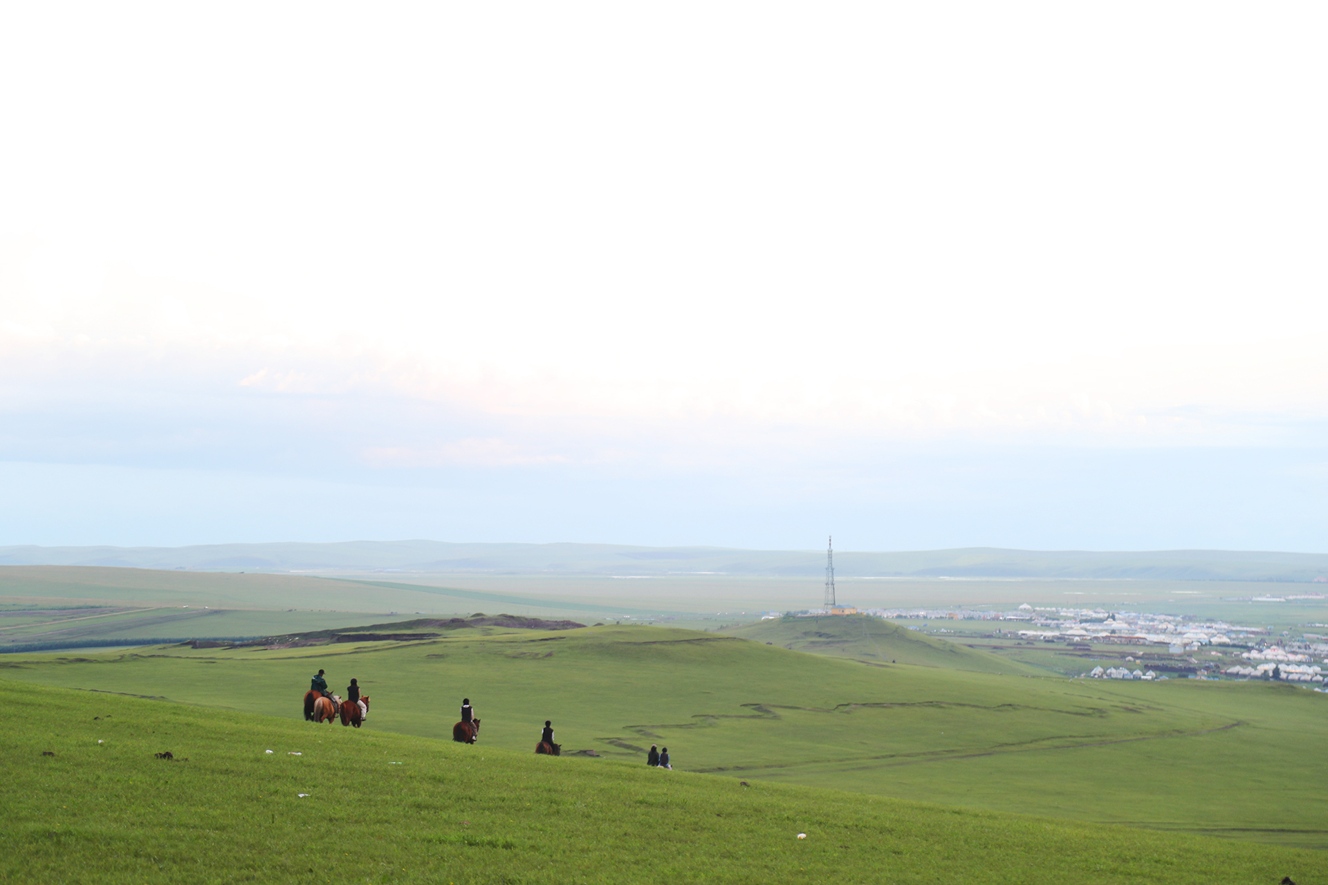 Visitors ride horses at sunset in Heishantou Town, Hulunbuir, Inner Mongolia. /CGTN
