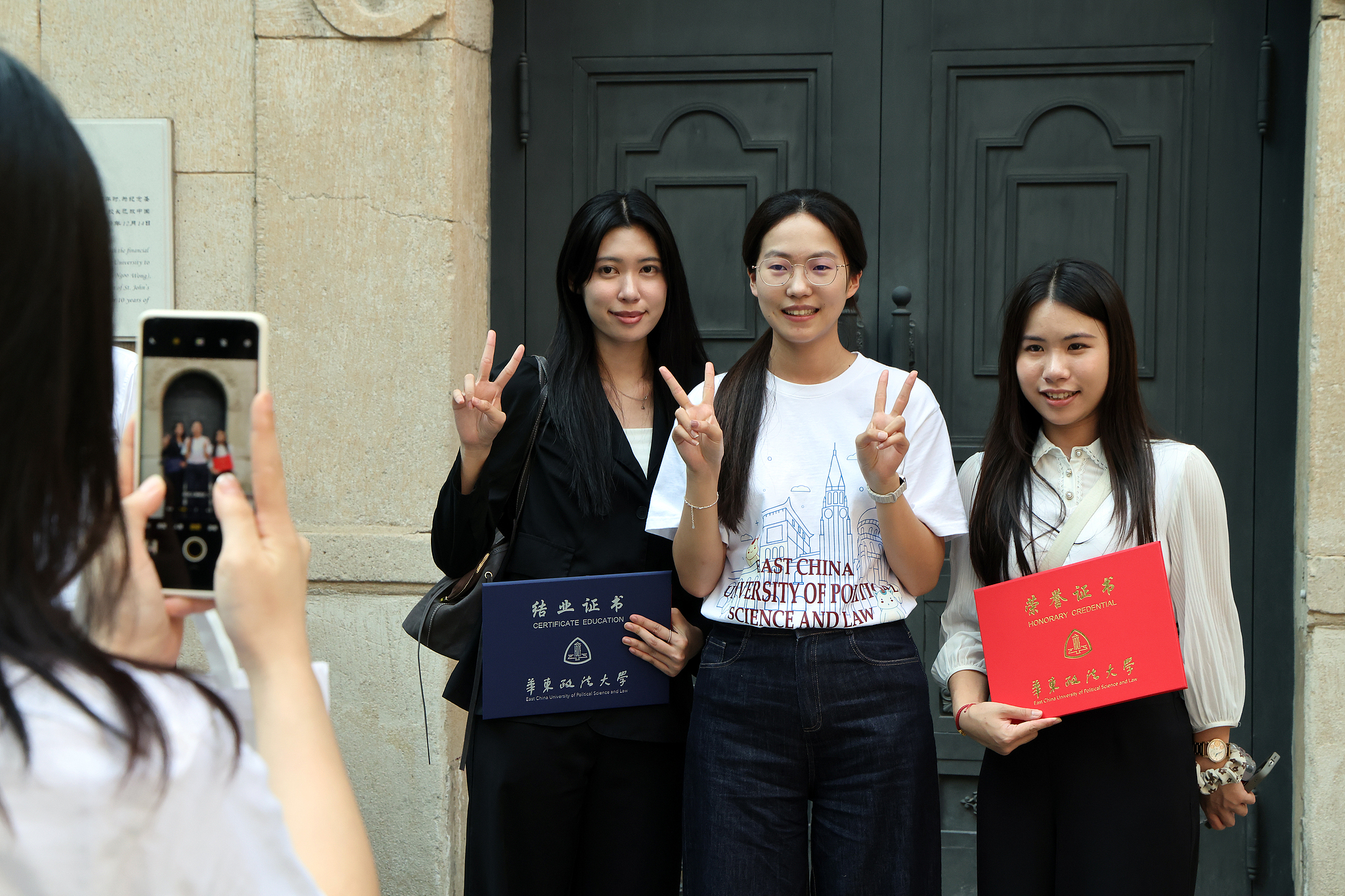 A trio poses for a group selfie after completing a month-long study program at the East China University of Political Science and Law, Shanghai, China, August 6, 2026. /CFP