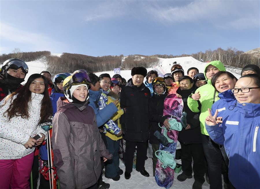 President Xi Jinping poses for a group photo with skiers at Genting Ski Resort, as he inspects preparatory work for Beijing 2022 Winter Olympic Games in Zhangjiakou, north China's Hebei Province, January 23, 2017. /Xinhua 