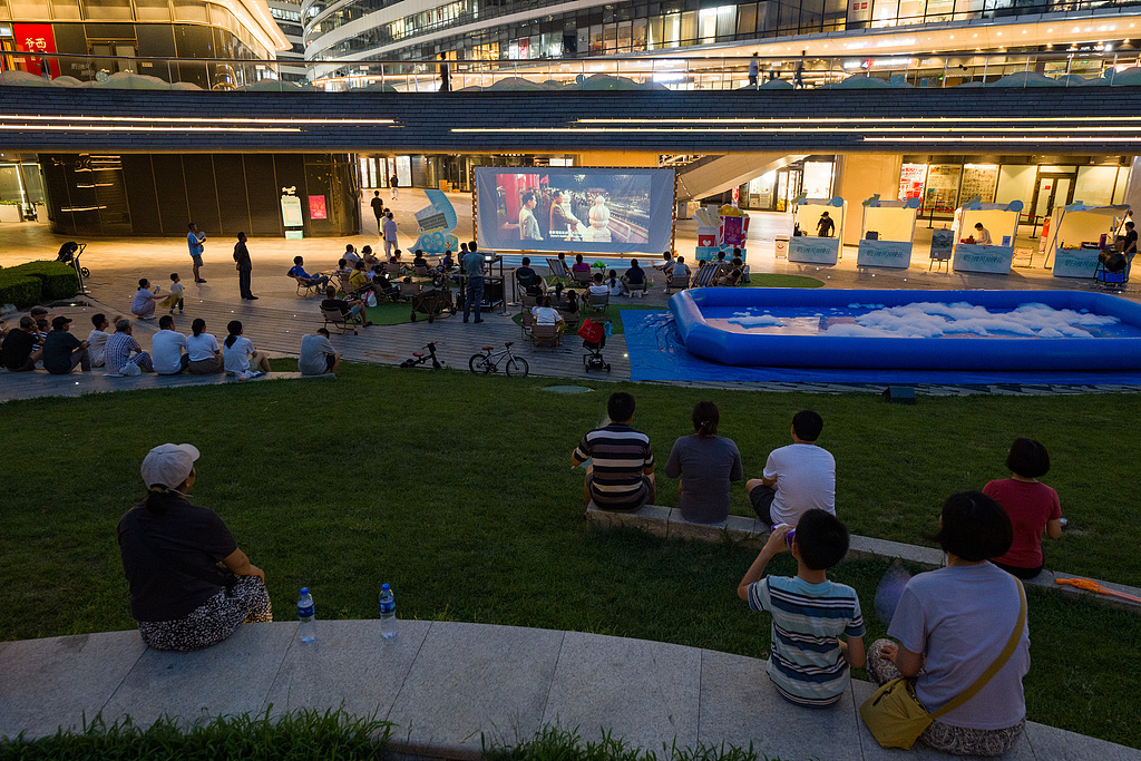 Residents in Beijing watch the previous Hundred Flowers Awards‑winning Best Film 