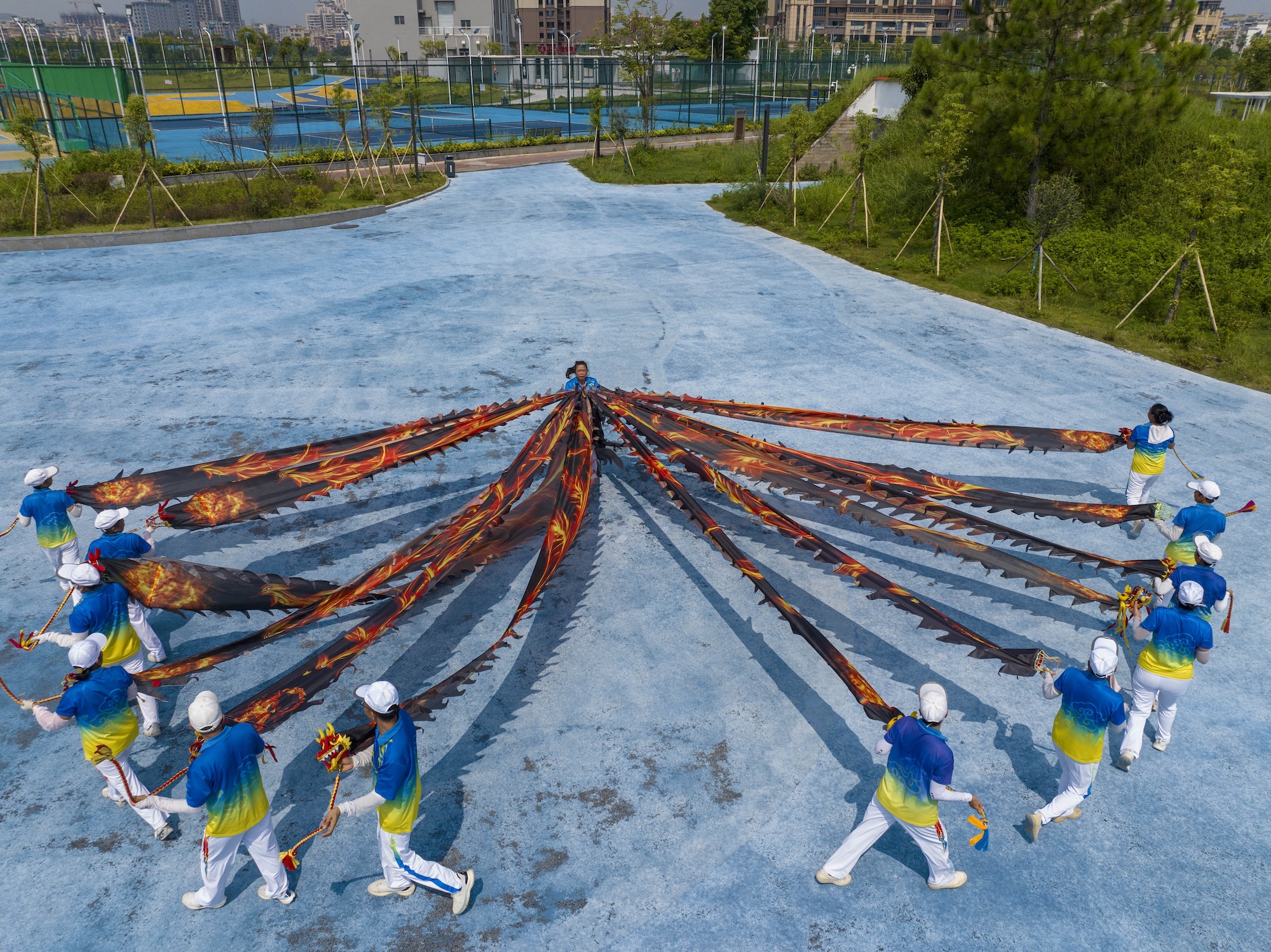 Residents perform a ribbon dragon dance to celebrate National Fitness Day at Canghai Sports Park in Wuzhou, south China's Guangxi Zhuang Autonomous Region on August 7, 2026. /IC