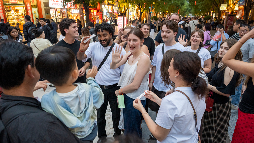 Foreign tourists visit the Qianmen pedestrian street in Beijing, China, May 25, 2026. /VCG
