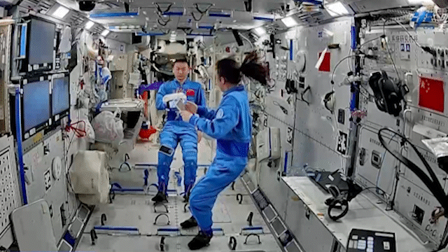 Chinese astronauts interact with robot Xiaohang. /CMSA