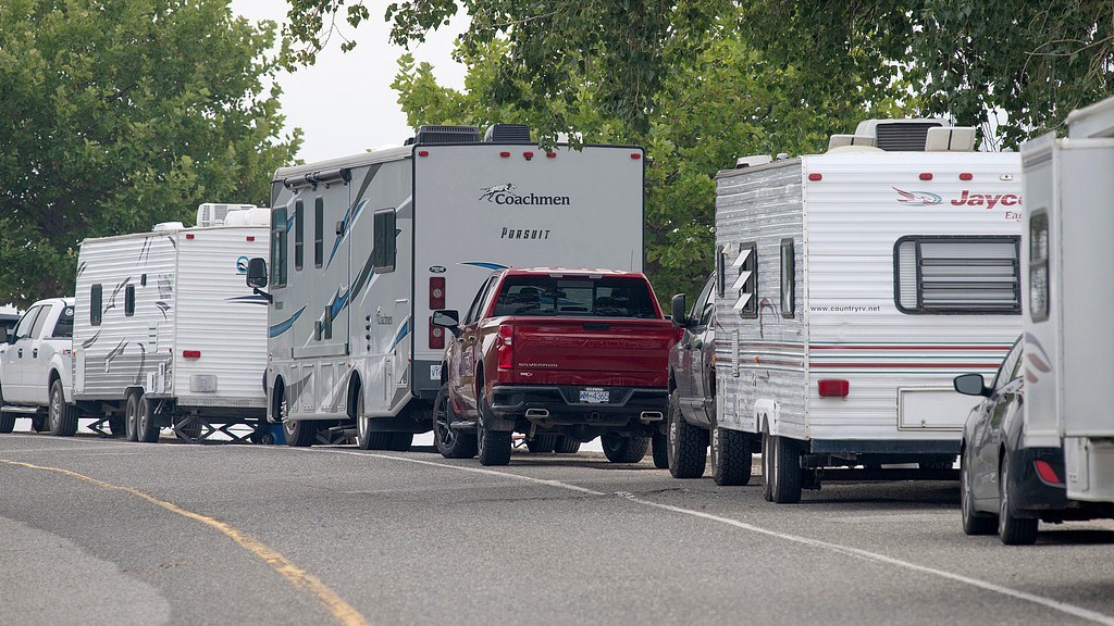 People with recreational vehicles who have been forced from their homes by wildfires line Beach Avenue in Peachland, British Columbia, August 8, 2026. /VCG