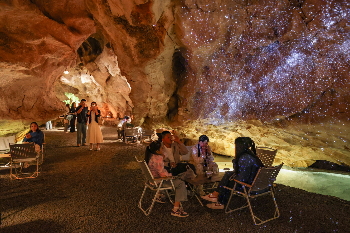 Young visitors enjoy coffee inside a 