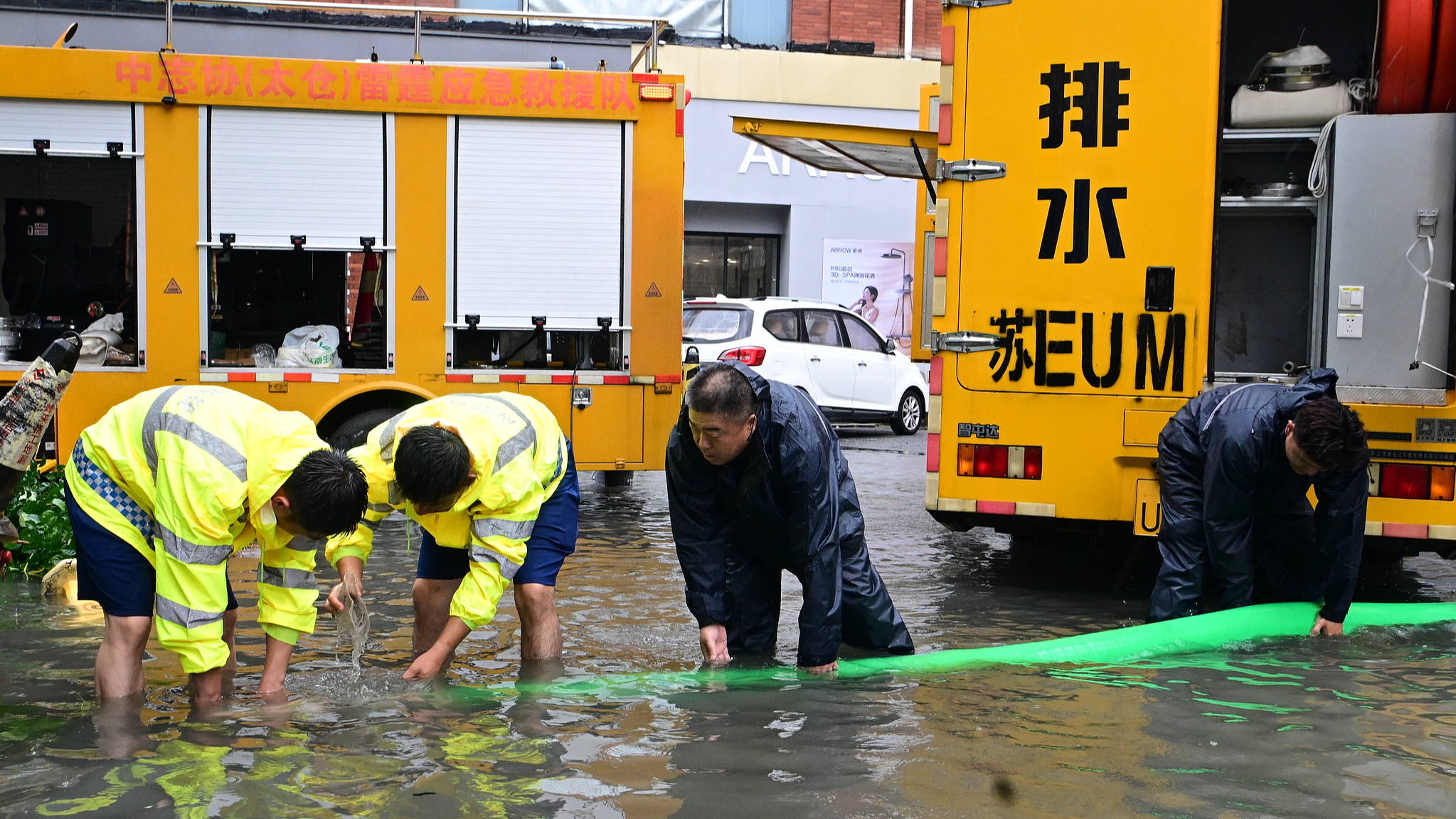 Workers conduct emergency drainage operations on flooded roads in Taicang City, east China's Jiangsu Province, after Typhoon Dolphin passed through the area, August 10, 2026. /VCG