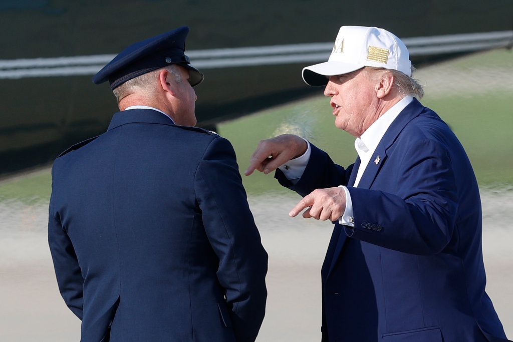 President Donald Trump, right, talks with Air Force Col. Christopher M. Robinson, commander, 89th Airlift Wing before boarding Marine One upon his arrival at Joint Base Andrews, Maryland, August 9, 2026. /VCG