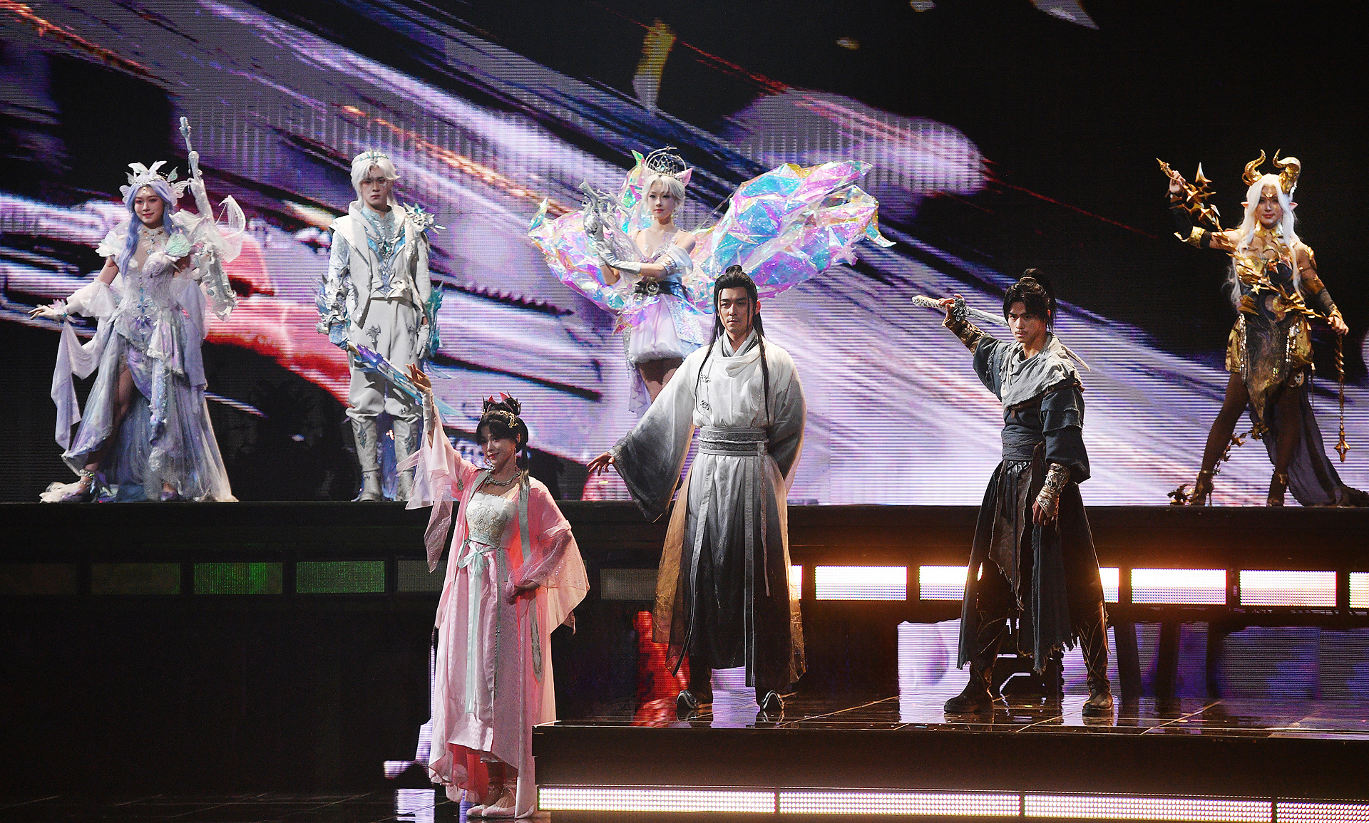 Performers appear onstage wearing diverse in-game outfits at the Peace Night event.