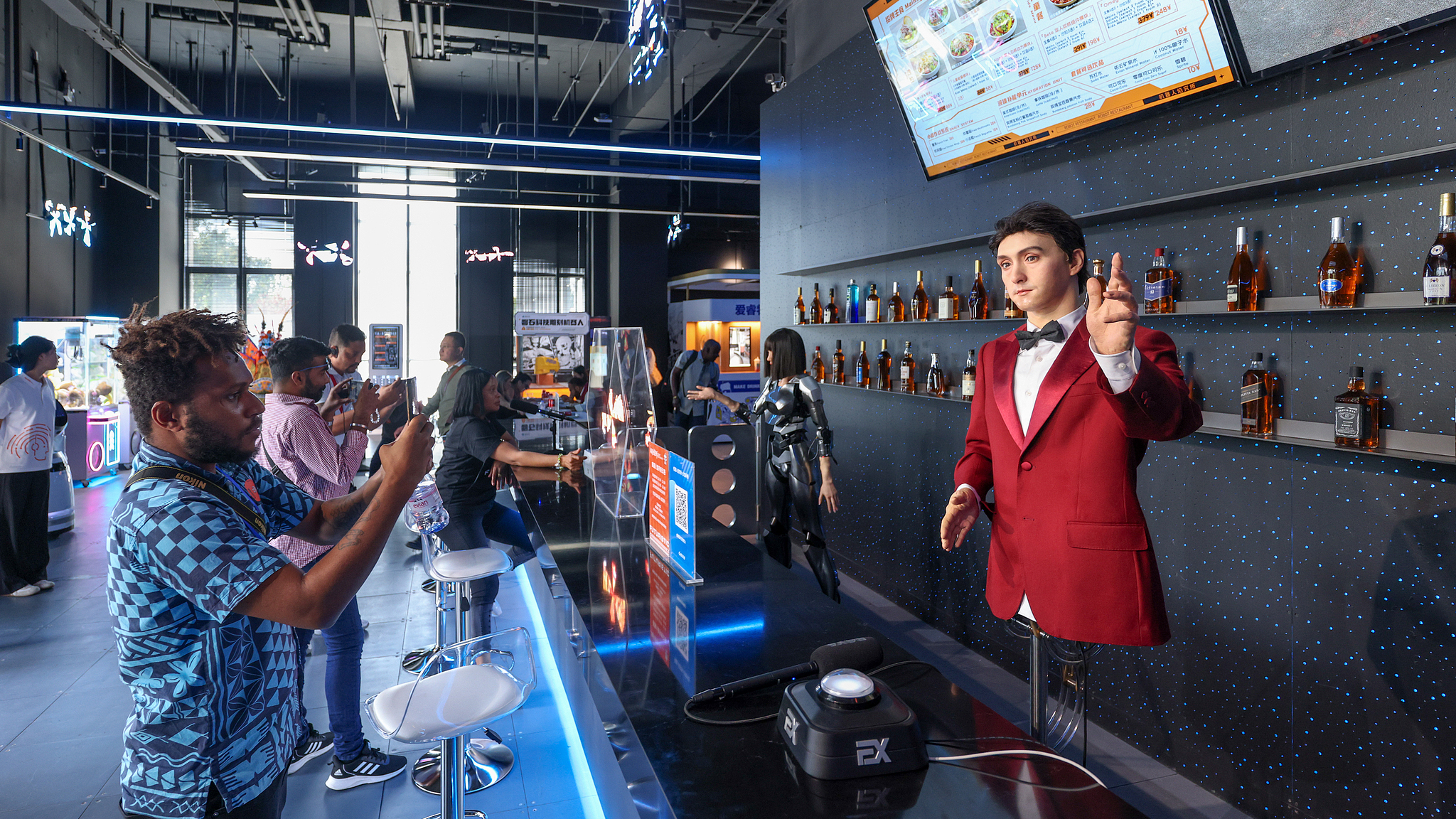 Journalists take photos inside a robot-themed restaurant in Beijing, China, September 29, 2025. /CFP