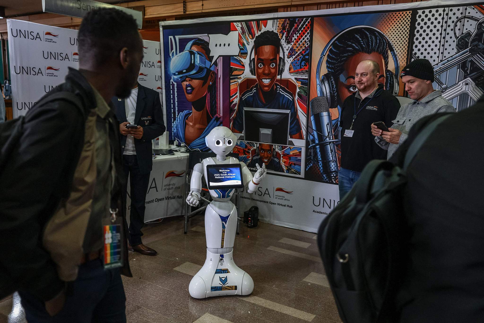 Delegates look at an AI-powered assistant as they arrive for the first National Convention at the University of South Africa (UNISA) in Pretoria, South Africa, August 15, 2025. /CFP