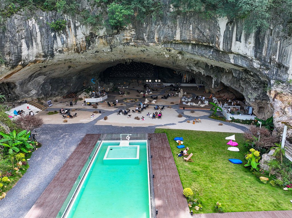 Visitors enjoy the cool surroundings of a cave cafe in Xiuwen County, Guizhou Province on August 10, 2026. /VCG