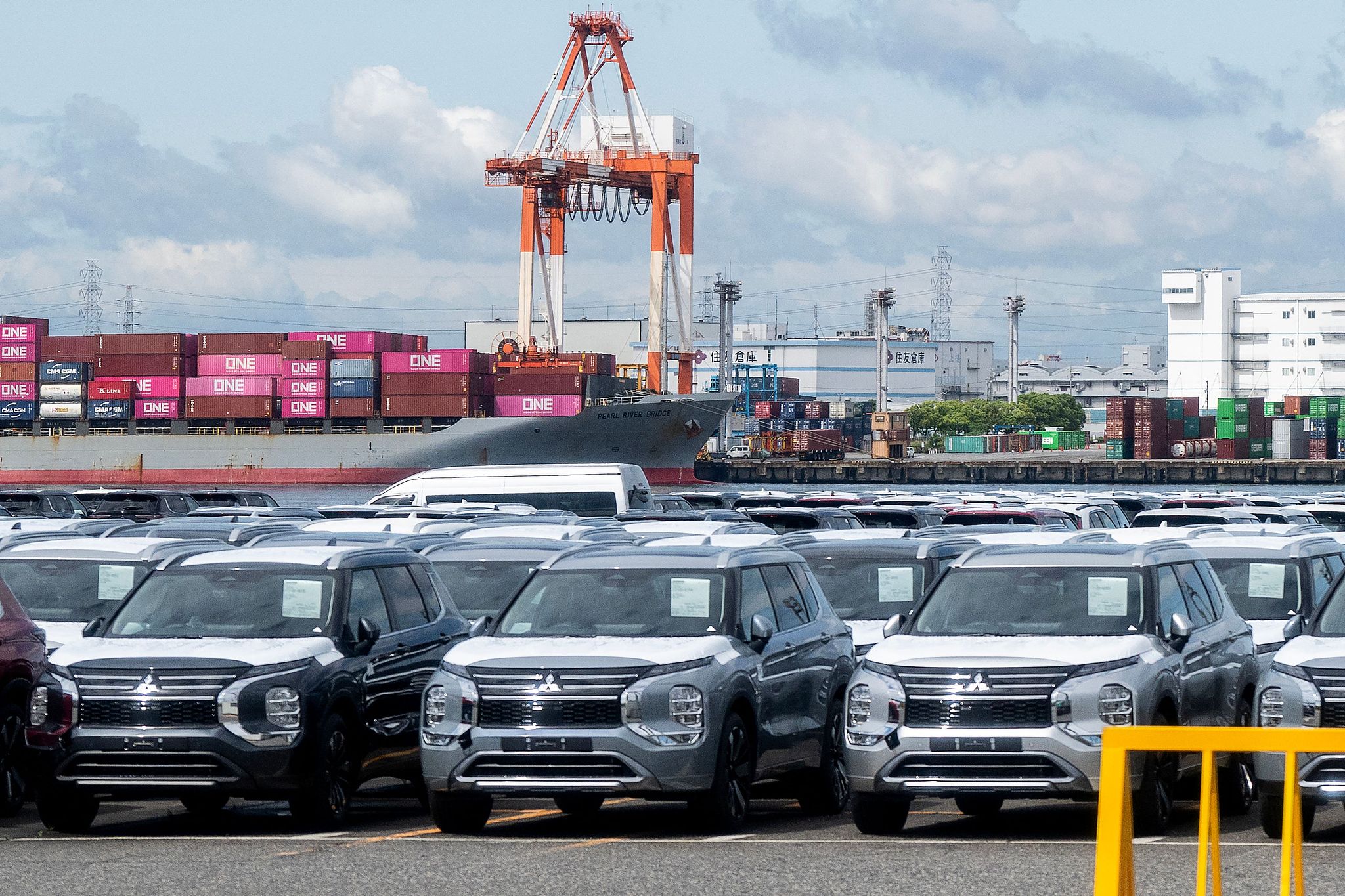 Japanese cars for export are pictured in front of a container ship at a port in Nagoya, Japan, May 22, 2026. /VCG