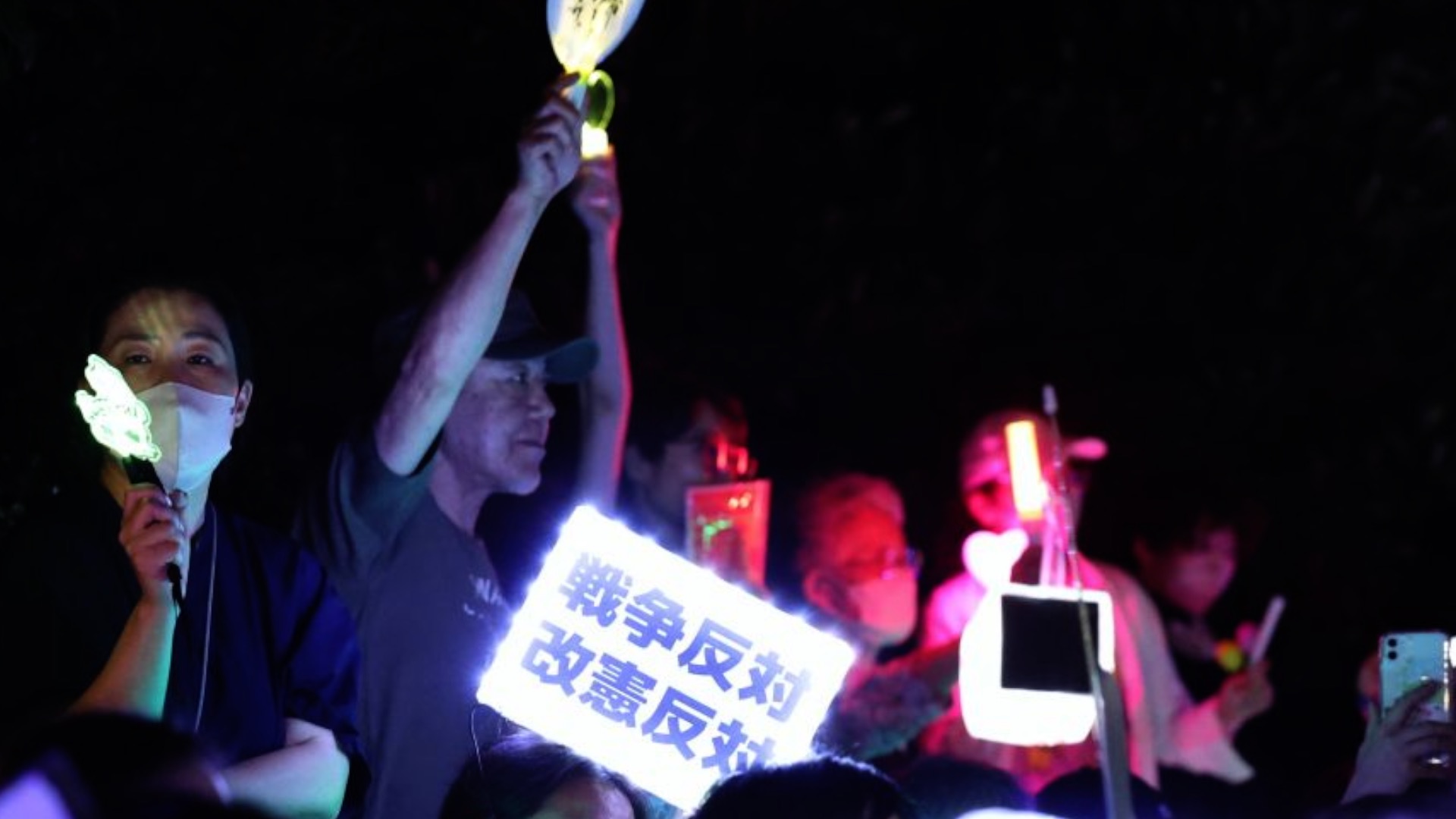 People holding signs attend an anti-war protest rally in front of the National Diet Building in Tokyo, Japan, July 10, 2026. /Xinhua