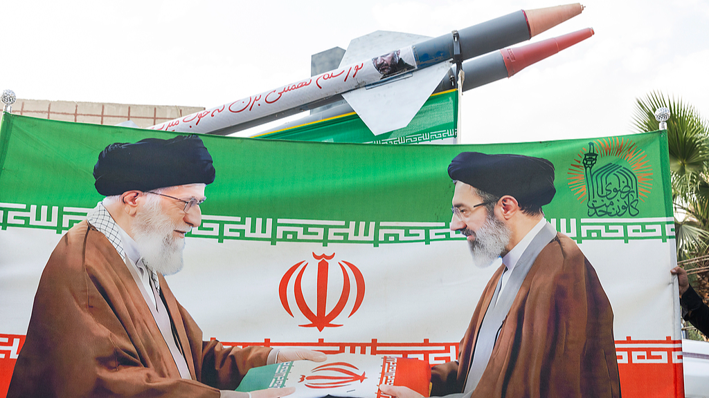 An image of Iran's former Supreme Leader Ali Khamenei, left, and new Supreme Leader Mojtaba Khamenei with replicas of missiles in the background during a gathering in Tehran, Iran, August 12, 2026. /VCG