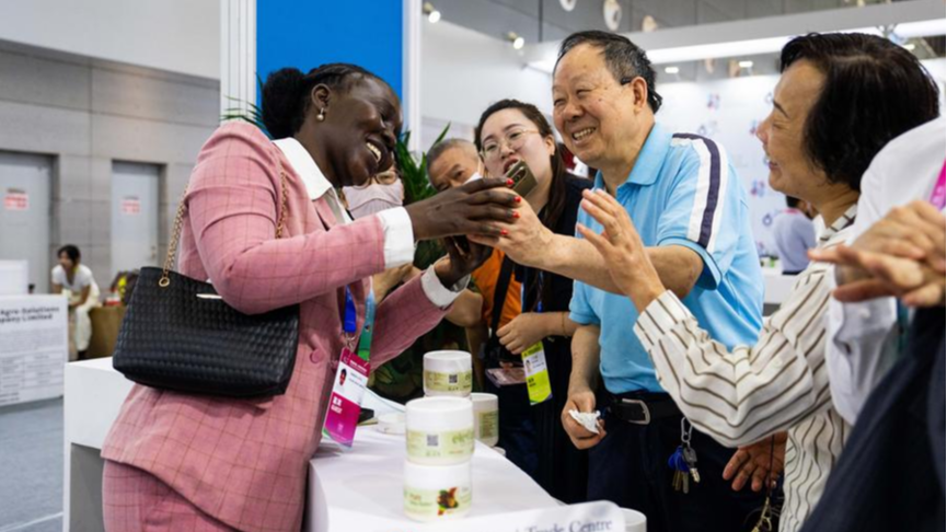 An exhibitor (L) chats with visitors during the fourth China-Africa Economic and Trade Expo at Changsha International Convention and Exhibition Center in Changsha, central China's Hunan Province, June 13, 2025. /Xinhua