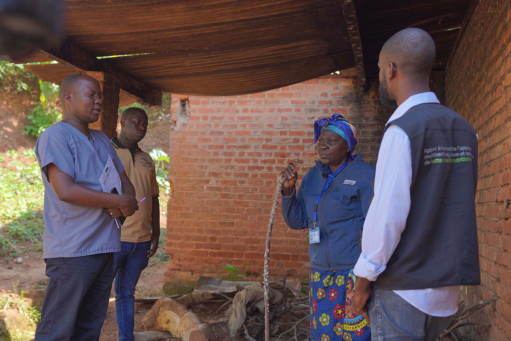 Gédéon Banga Ngbape, left, an Ebola surveillance officer, does contact tracing in Nizi, Ituri province, eastern Democratic Republic of the Congo, August 14, 2026. /VCG