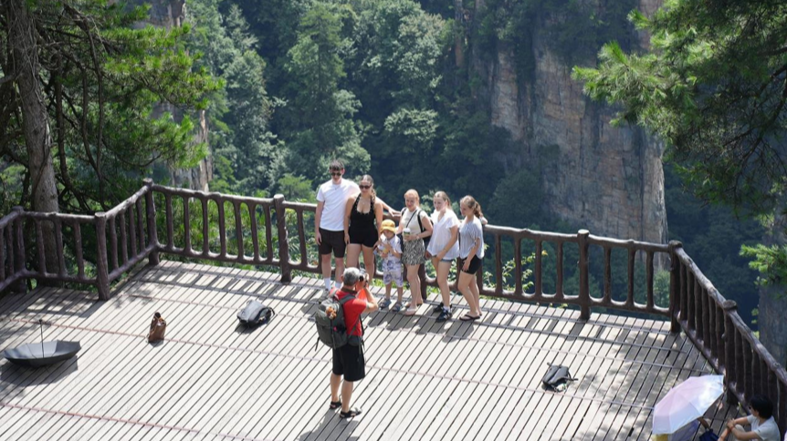 Foreign tourists take group photos Tianzi Mountain in Zhangjiajie National Forest Park in Zhangjiajie, Hunan Province, July 30, 2026. /Xinhua