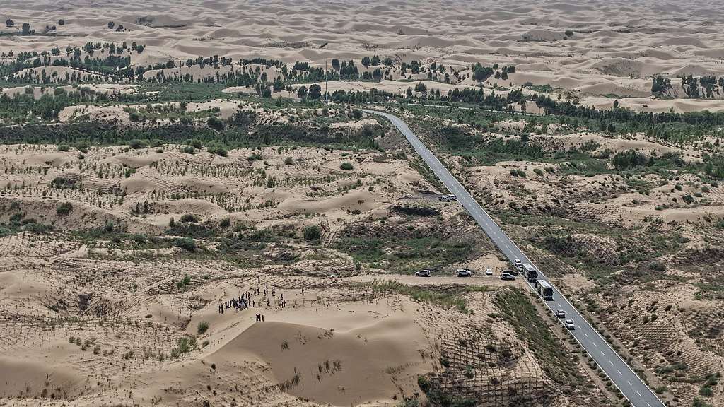 A highway cuts through a desertification control site of the Engebei Ecological Area near Ordos in north China's Inner Mongolia Autonomous Region, June 12, 2026. /VCG