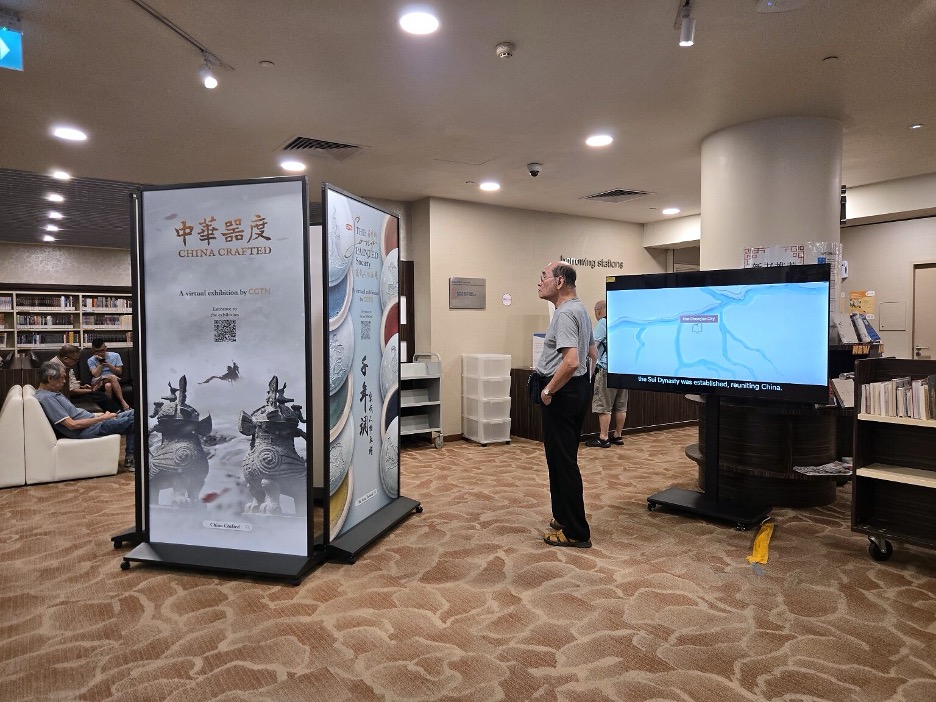 A visitor pauses at the China Crafted display at Singapore's Chinatown Library. /CGTN 