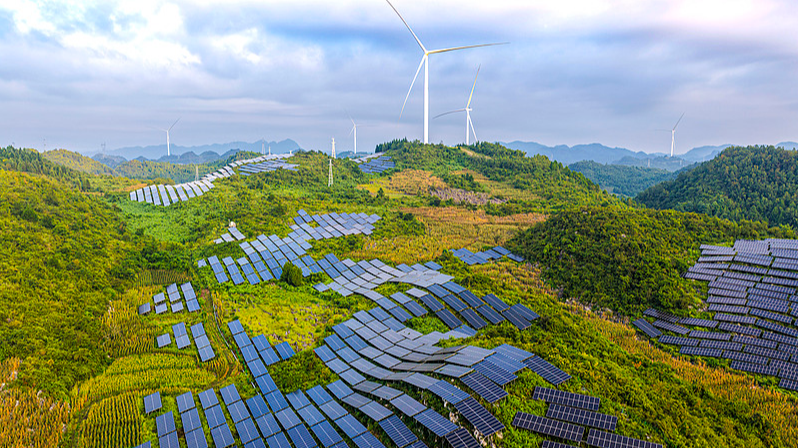 Photovoltaic panels are neatly arranged against a backdrop of lush green mountains in Dingxin Yi and Miao Ethnic Township, Qianxi City, southwest China's Guizhou Province, August 17, 2026. /CFP