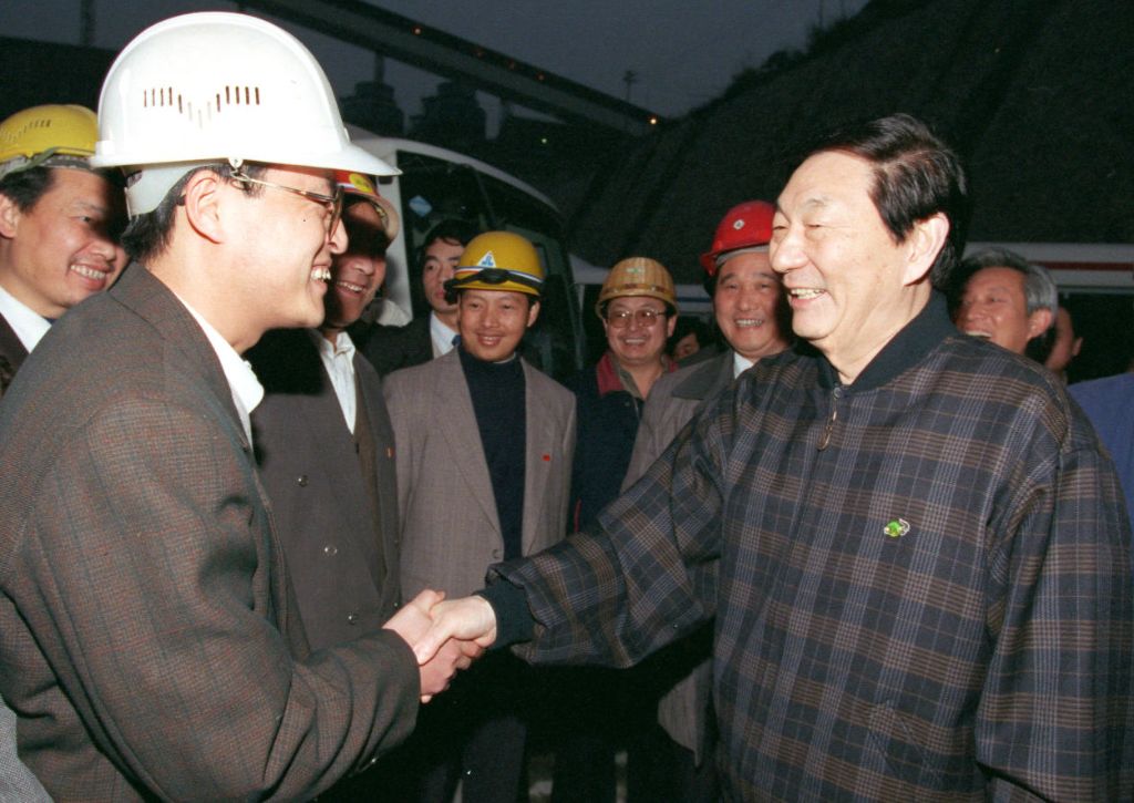 Zhu Rongji shakes hands with a technical worker at the construction site of the Three Gorges project, December 29, 1998. /Xinhua