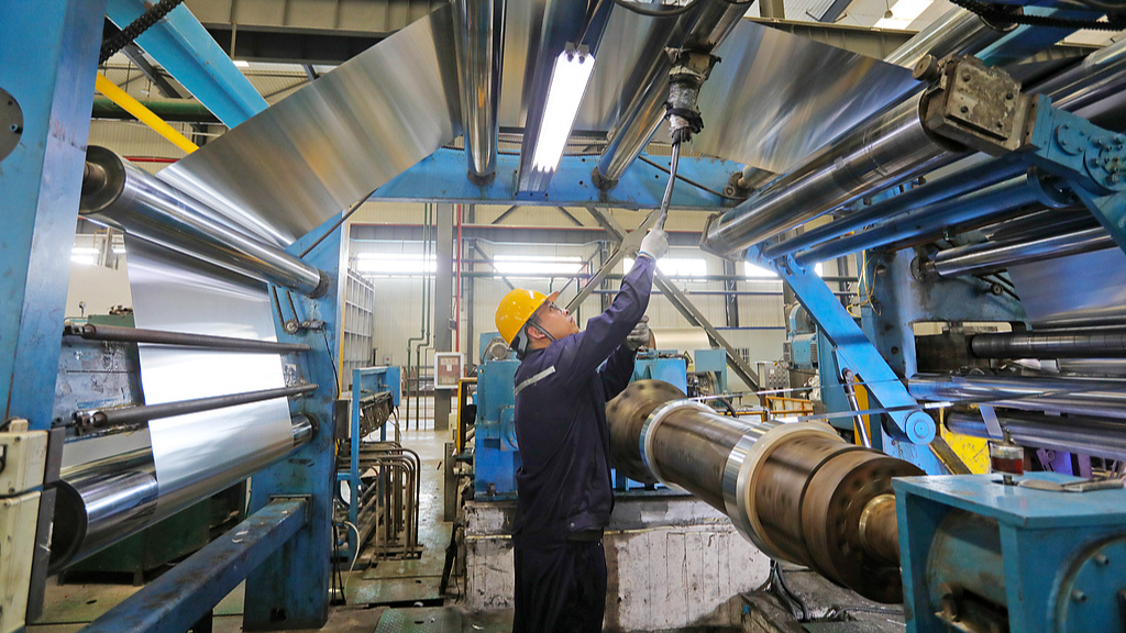 A worker operates equipment at a new material manufacturing factory, Huaibei City, east China's Anhui Province, August 17, 2026. /VCG
