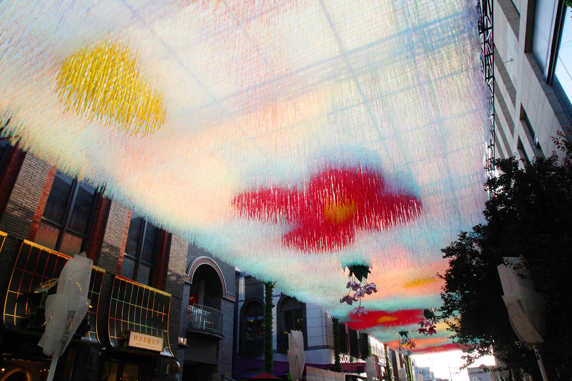 A view of the flower-themed art canopy over Langfang Toutiao Hutong in Beijing's historic Qianmen area. /CGTN