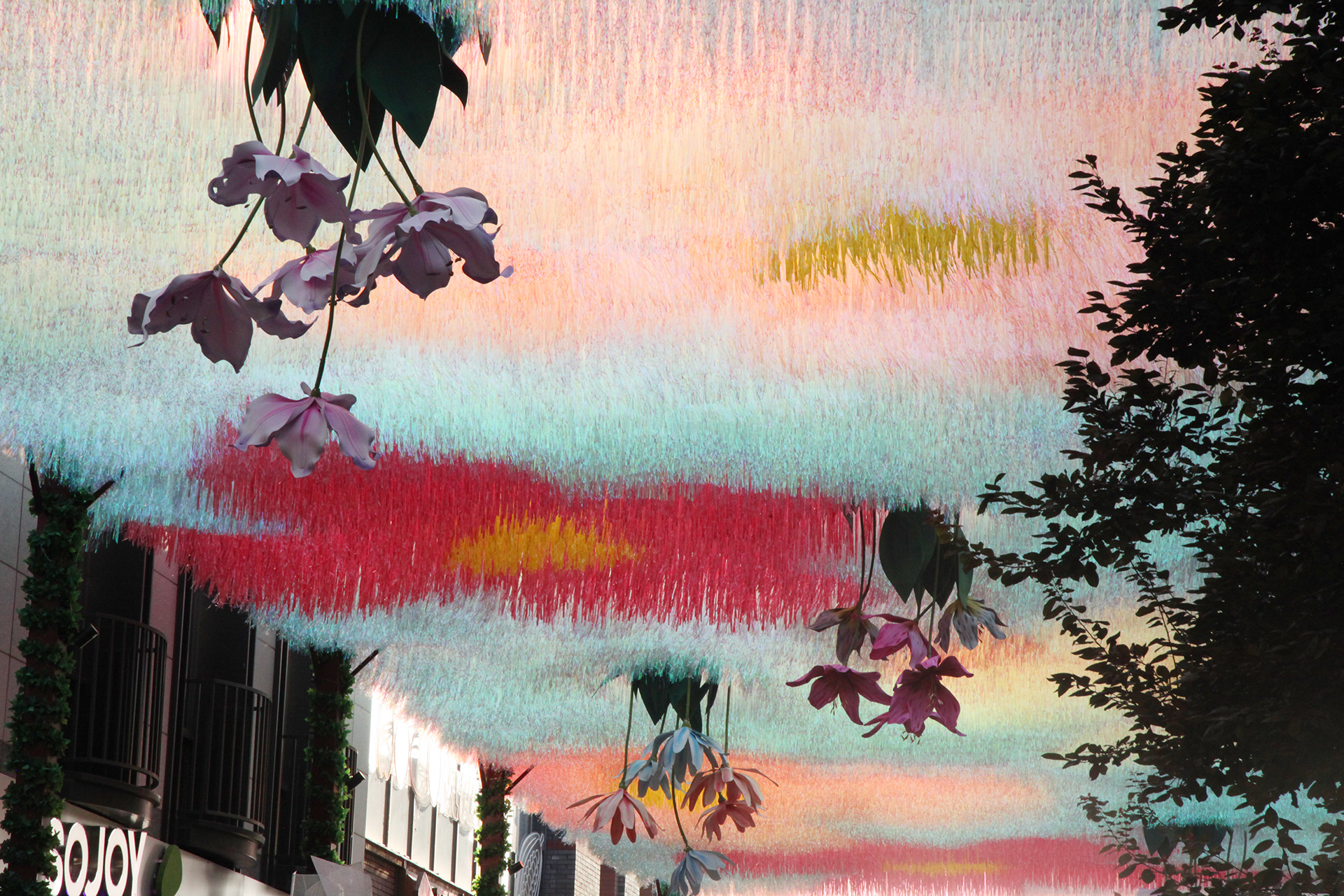 A view of the flower-themed art canopy over Langfang Toutiao Hutong in Beijing's historic Qianmen area. /CGTN