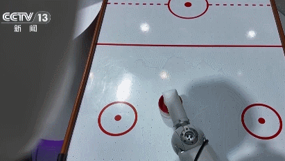 A robot playing an air hockey challenge with its human rival. /CMG