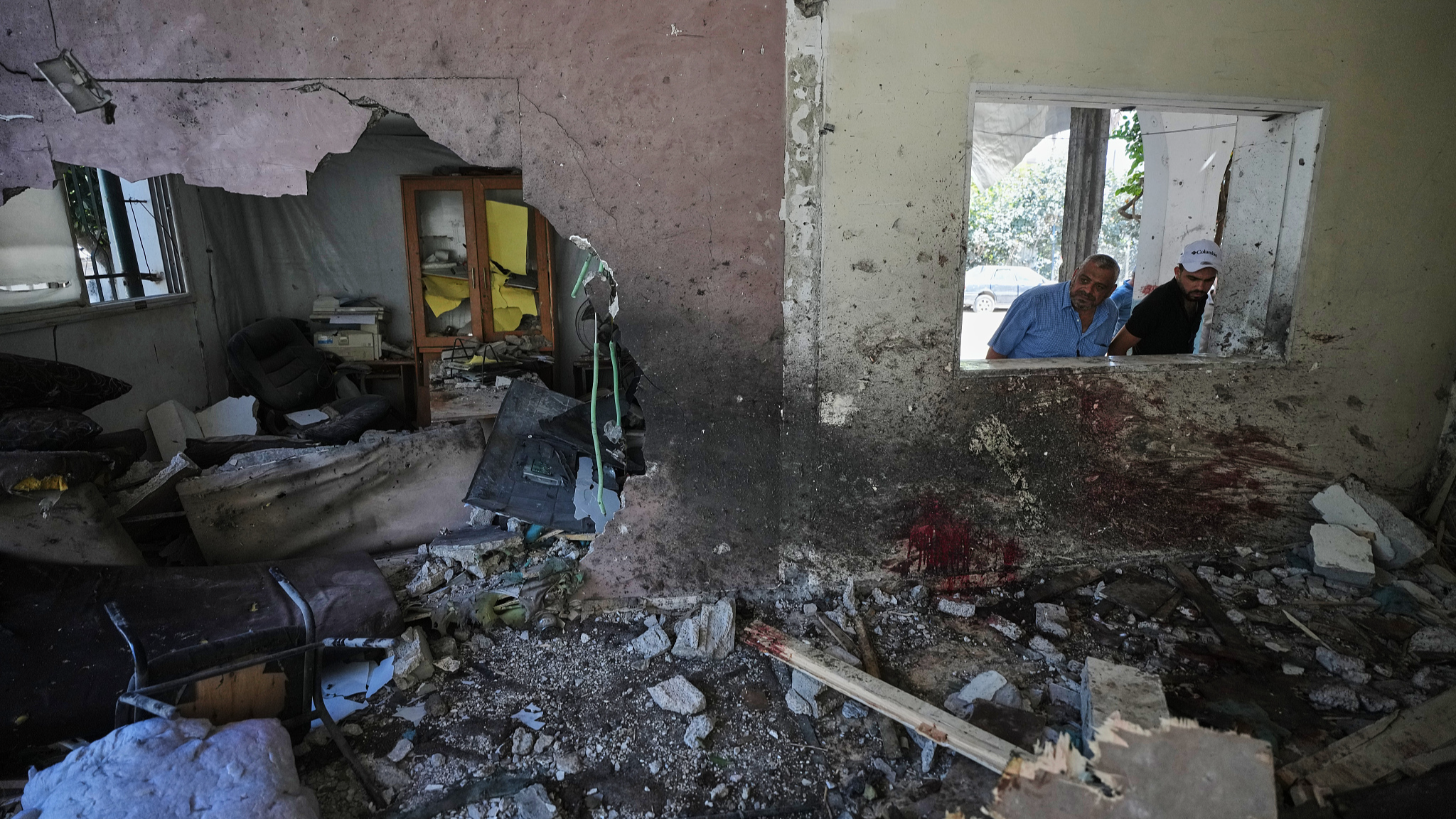 Palestinians inspect the damage at a police station that was hit by an Israeli air strike in Gaza City, Wednesday, August 19, 2026. /VCG