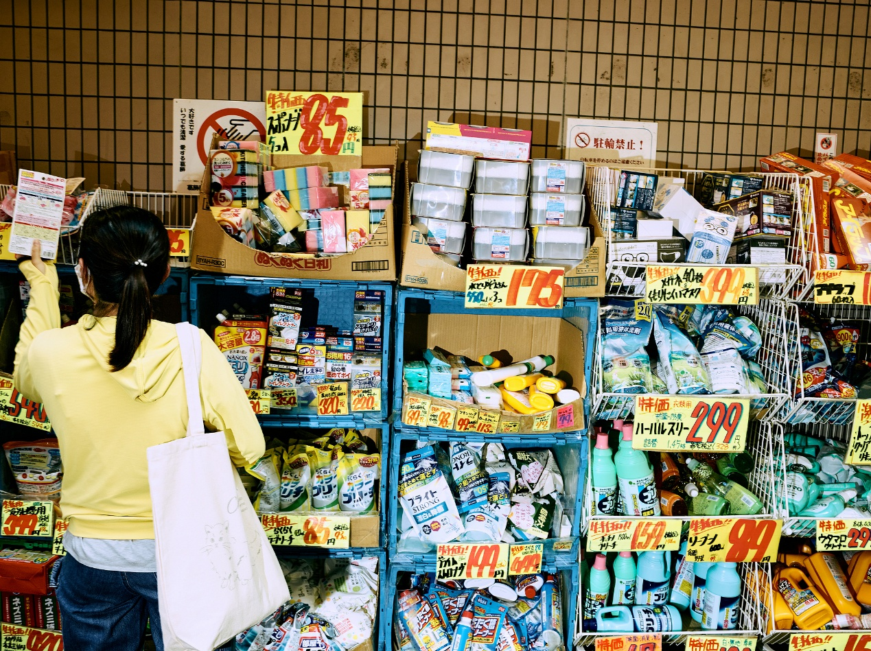 A customer looks at products on display outside a drug store in Tokyo, Japan, July 22, 2026. /VCG