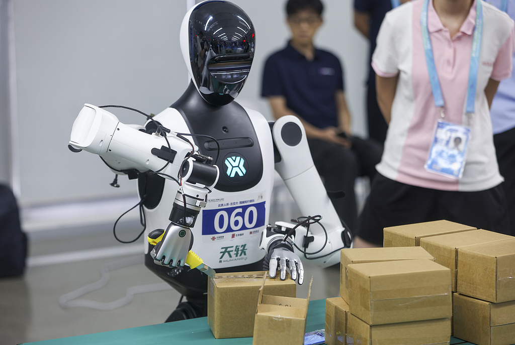 A robot competitor performs a package-unboxing task during the dexterous hand competition at the second World Humanoid Robot Games in Beijing on August 17, 2026. /VCG