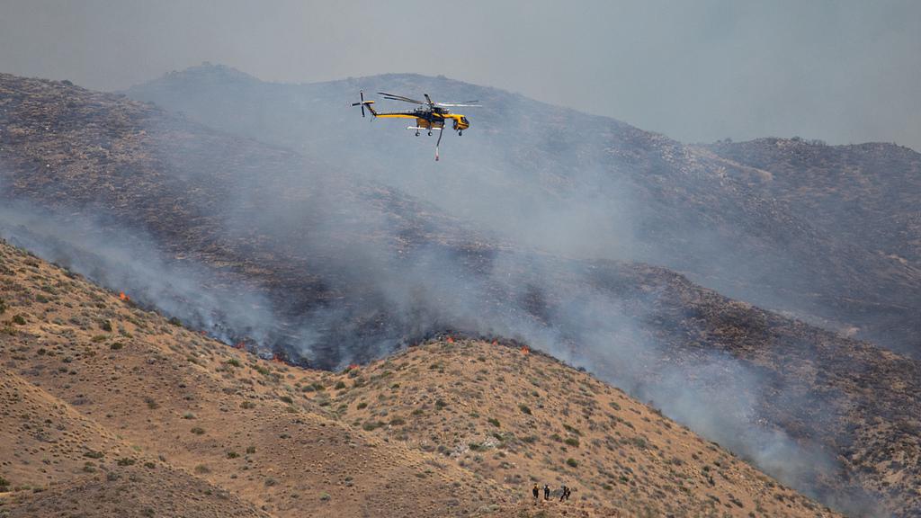 Fast-moving wildfire in Nevada injures 6, forces 42,000 to evacuate