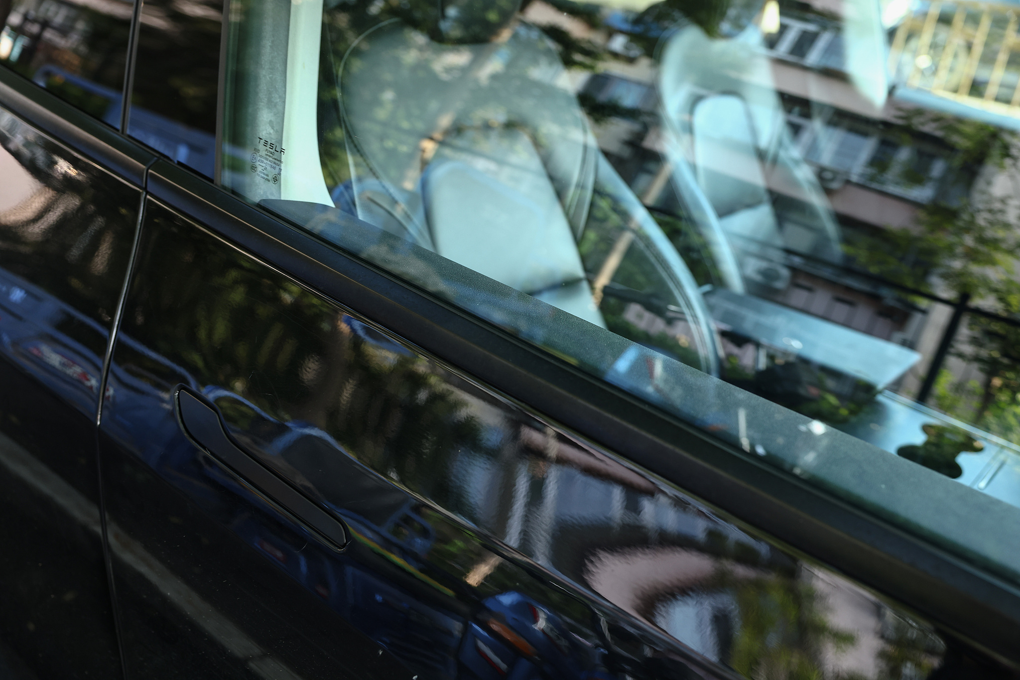 A general view of a Tesla electric vehicle car door handle in Beijing, China, on August 24, 2026. /VCG