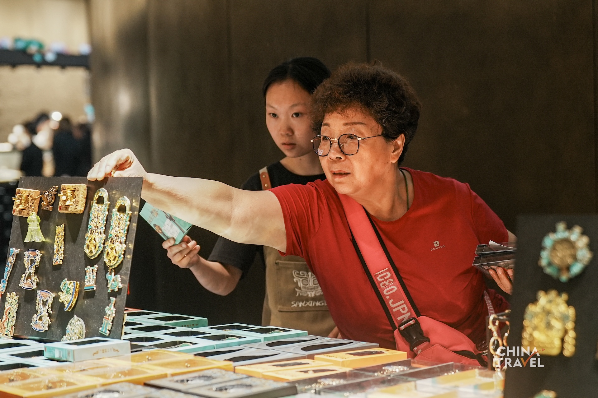 Cultural and creative products inspired by Sanxingdui artifacts bring the museum's iconic bronze figures and masks into everyday life. /CGTN