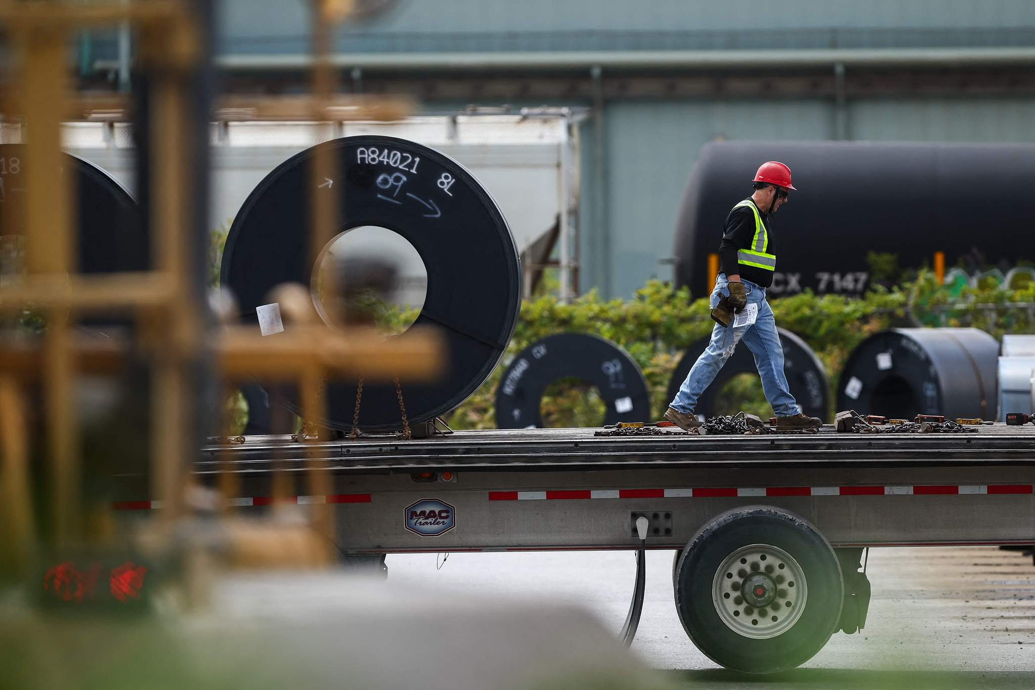 A worker prepares coils of steel for transport at an ArcelorMittal Dofasco facility in Hamilton, Ontario, Canada, August 24, 2026. /VCG