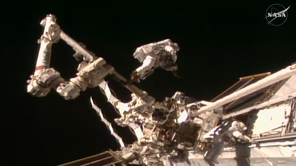 A frame grab from a NASA live video stream shows NASA astronaut Anil Menon (L) and ESA astronaut Sophie Adenot (R) working during their spacewalk outside the International Space Station, August 25, 2026. /VCG
