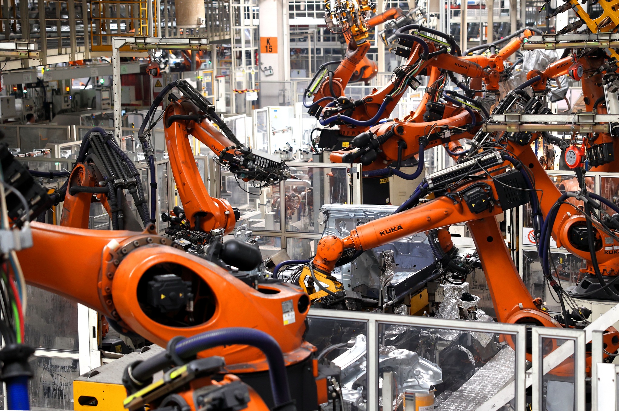 Robots seen engaged in welding operations at the welding workshop of the Volkswagen China East Region Base, Qingdao, Shandong Province, China, August 18, 2026. /VCG