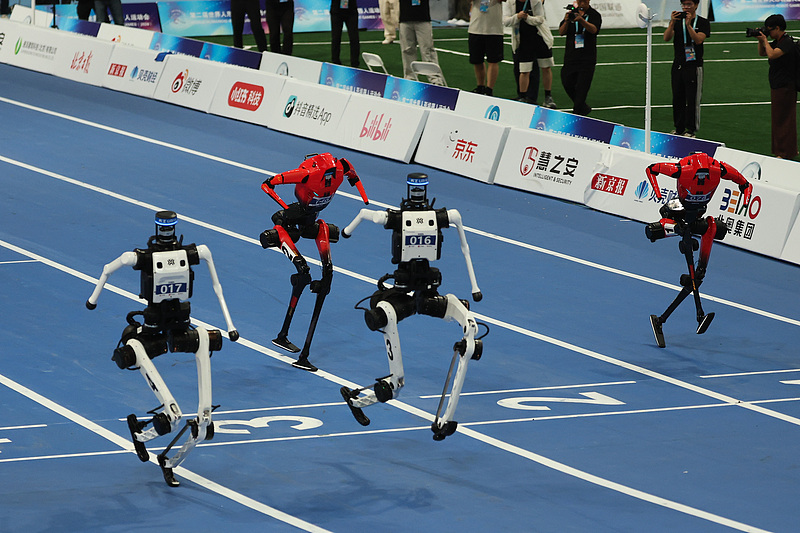 Humanoid robots compete in the 100 m final during the 2nd World Humanoid Robot Games at the National Speed Skating Oval in Beijing, China, August 26, 2026. Tiangong Ultra ultimately won first place with a 8.64-second time. /VCG