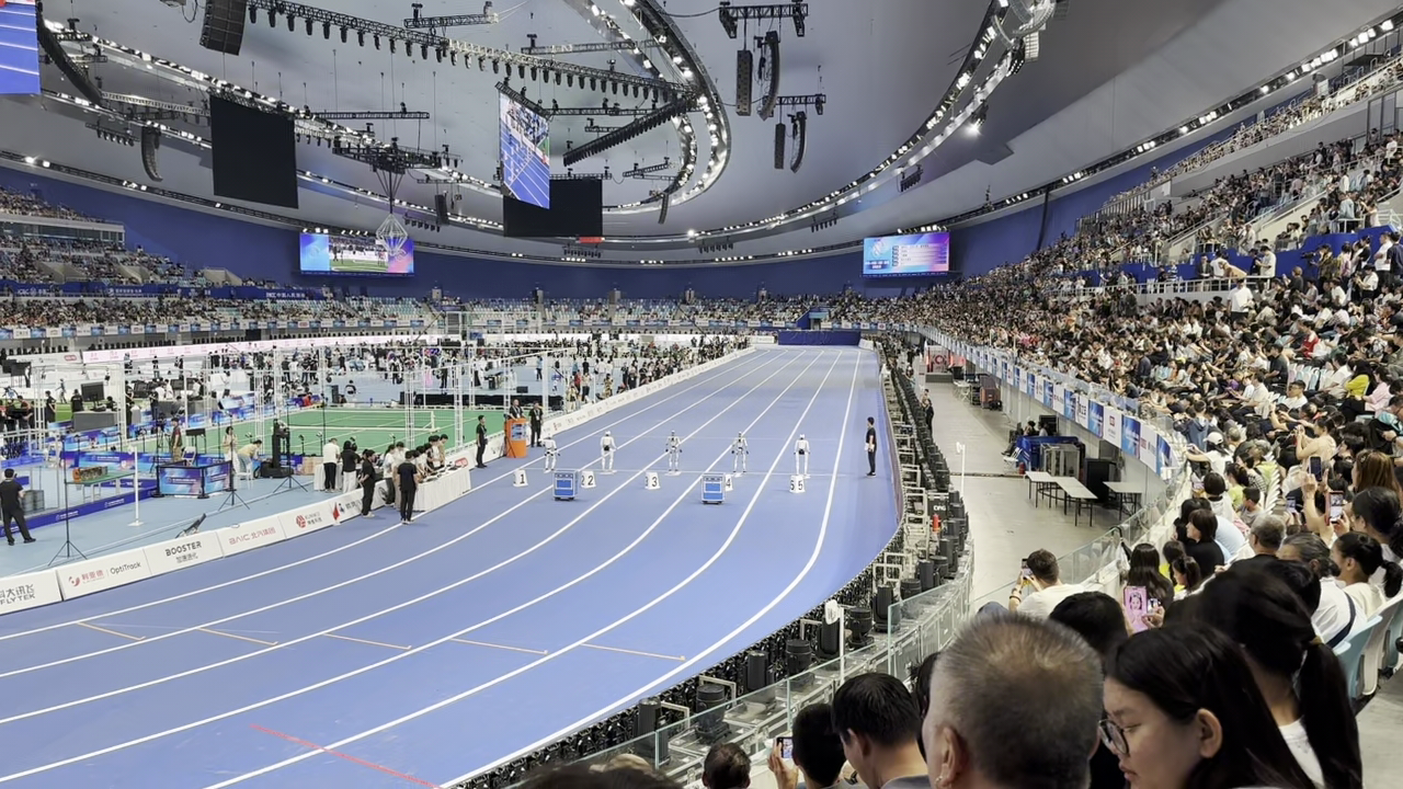 Humanoid robots line up on the running track while other competitions of the 2nd World Humanoid Robot Games 2026 are held on the field of the National Speed Skating Oval in Beijing, China, August 25, 2026 ./Ankit Prasad