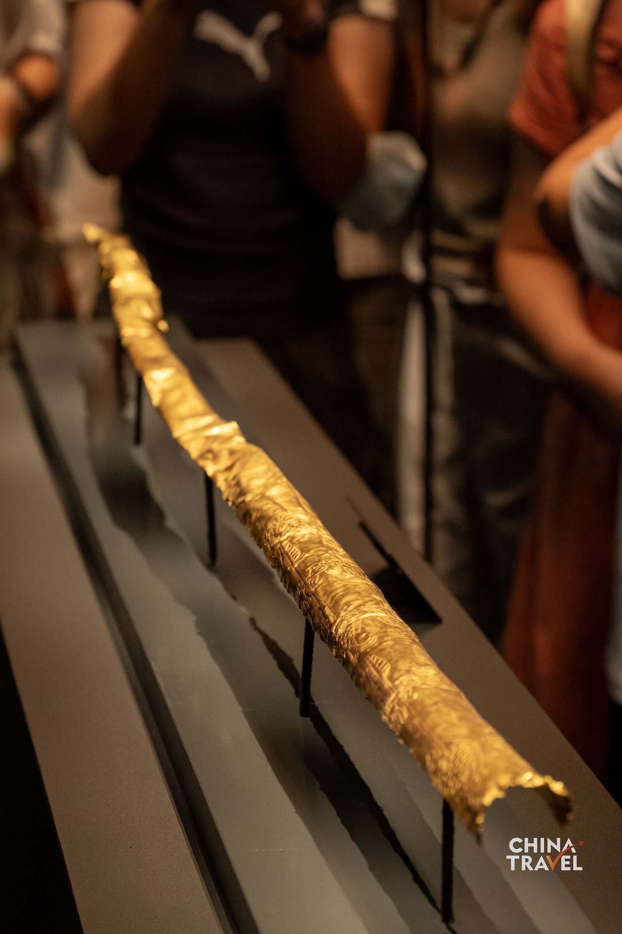 Sanxingdui's gold scepter is decorated with images of fish, birds, arrows and human figures. Its gold foil is believed to have once covered a wooden core. /CGTN
