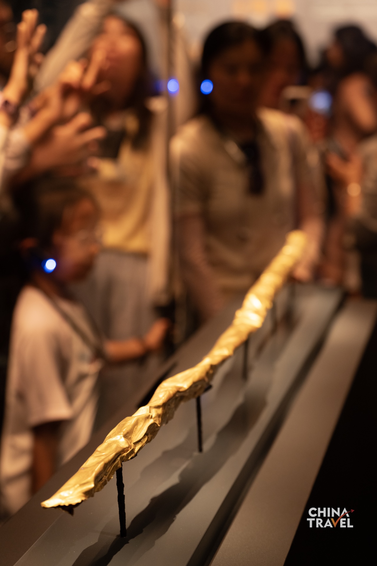 Sanxingdui's gold scepter is decorated with images of fish, birds, arrows and human figures. Its gold foil is believed to have once covered a wooden core. /CGTN