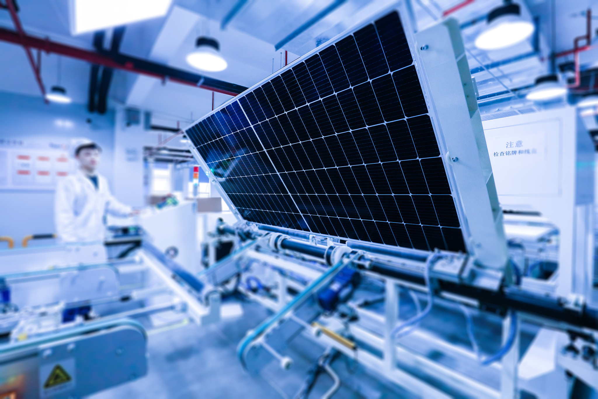 A file photo of workers handling newly manufactured solar panels on a production line at a factory. /CFP