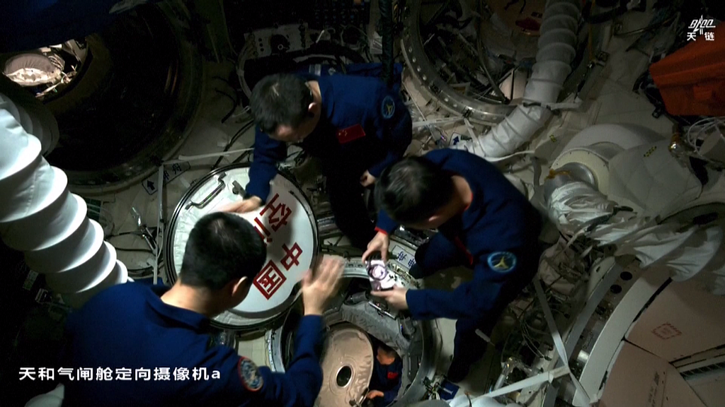 The Shenzhou-21 crew welcomes the newly arrived Shenzhou-23 astronauts aboard the China Space Station after opening the hatch, May 25, 2026. /VCG
