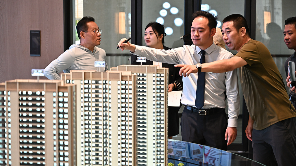 People look at property models inside a sales office in Taiyuan, Shanxi Province, China, July 20, 2026. /VCG